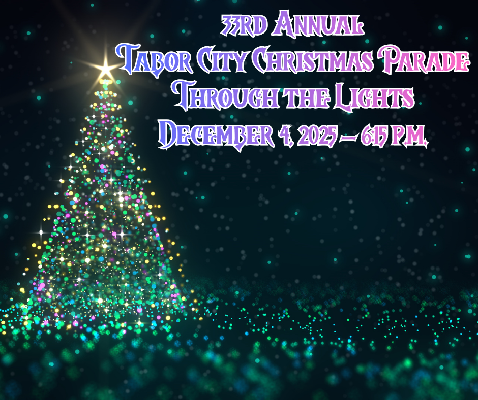 shape of a christmas tree with a star on top, the shape created by christmas theme colored lights and green/blue stars in the dark sky behind it.